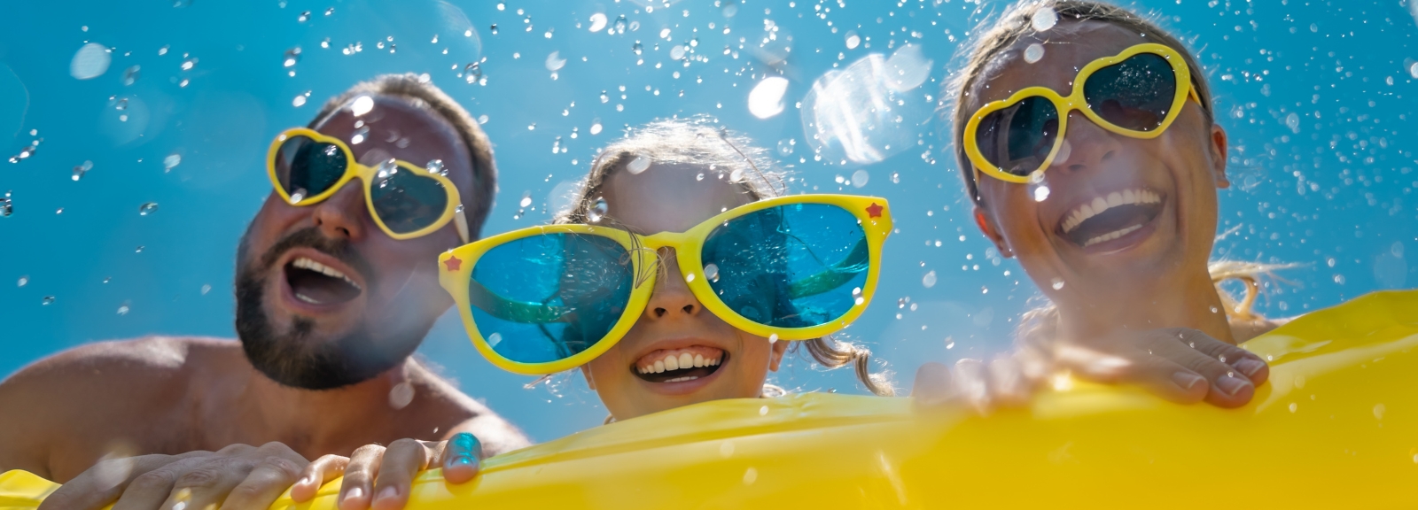 family in yellow glasses on water float
