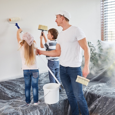 dad and two kids painting walls