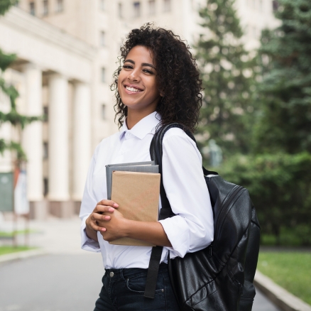 student holding books