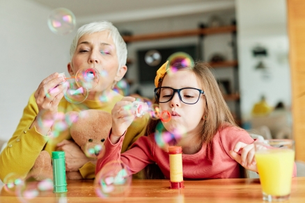 woman and child blowing bubbles