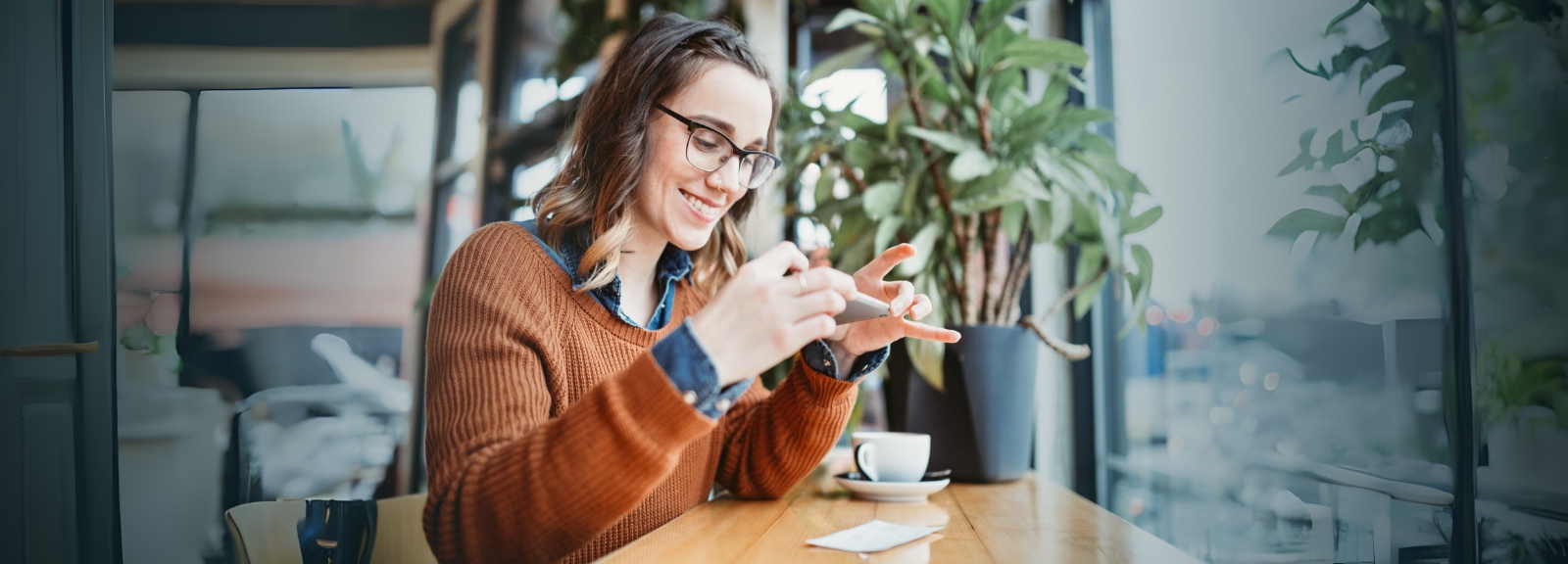 young woman taking photo of check