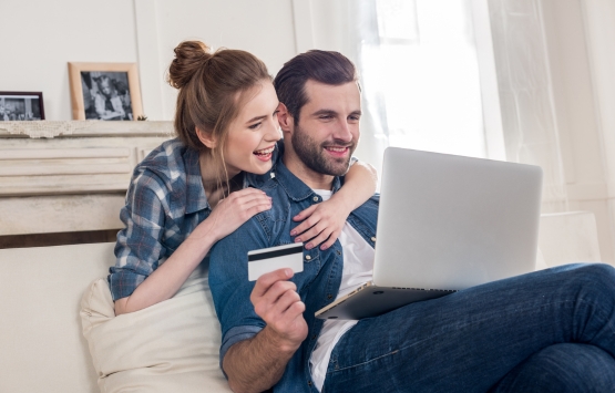 couple looking at computer and credit card