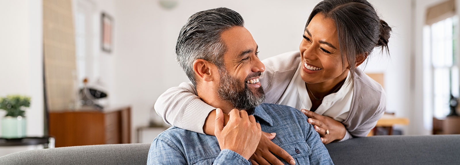 Couple hugging in living room