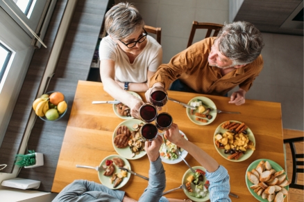 four people at table with wine