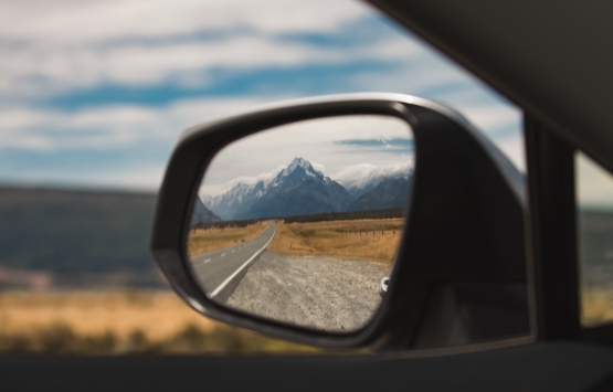 rearview mirror with mountain in reflection