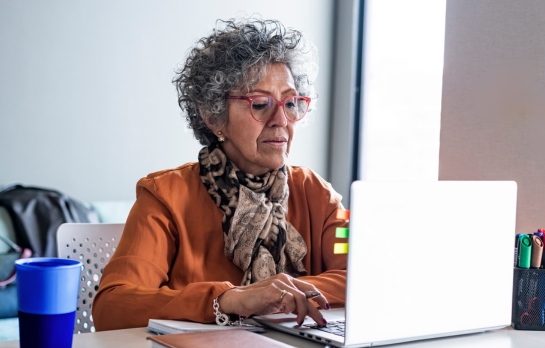 Woman in scarf looking at computer