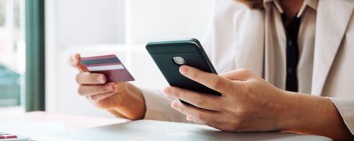 hand holding phone and card