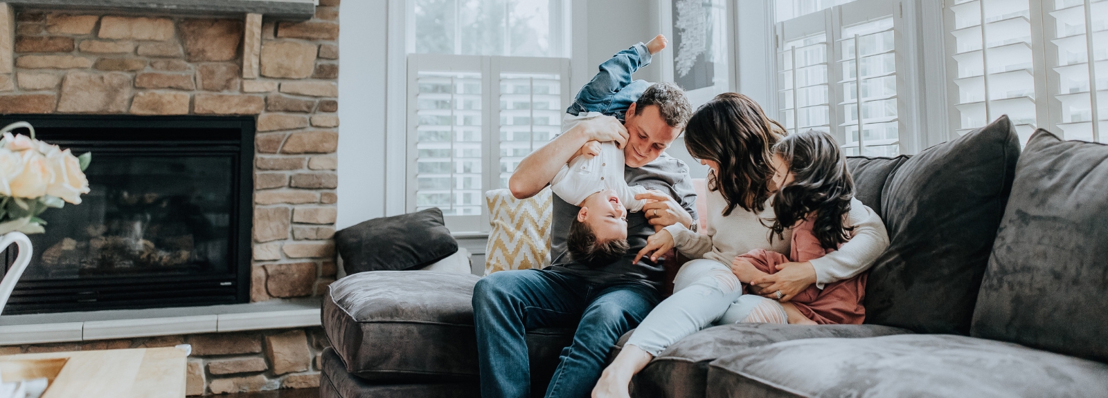 family of 4 in living room
