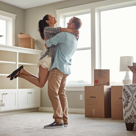 man holding woman up in hug