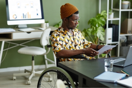 Man in wheelchair looking at papers