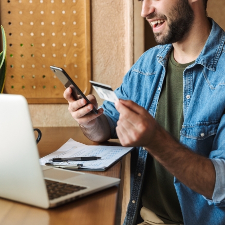 man holding phone and card