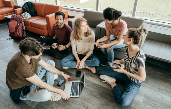 five people sitting in a group