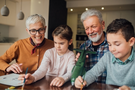 older couple sitting with grandchildren