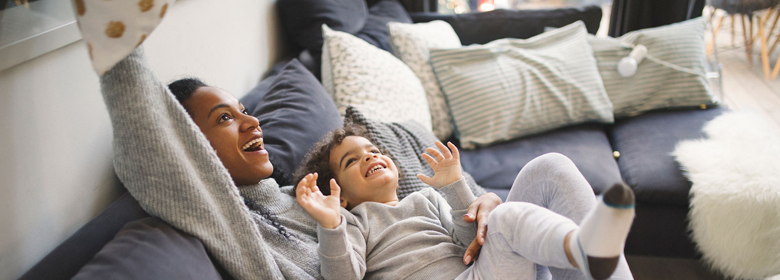 Mother and child playing on couch