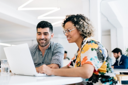 Man and woman looking at computer