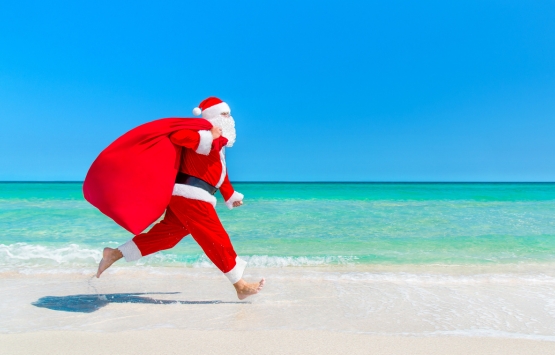 Santa running on the beach