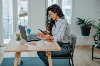 woman with brown hair looking at finances
