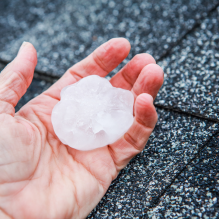 Hand holding hail. Wyoming Hail Damage WyHy