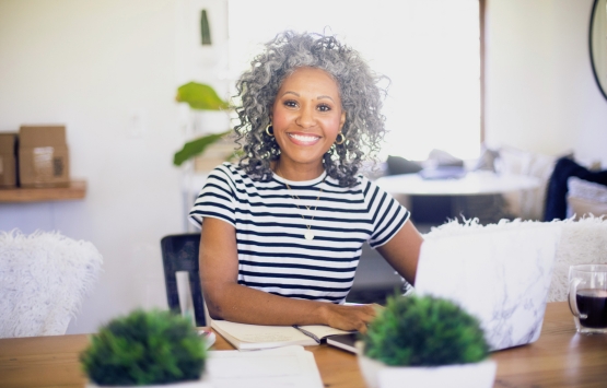 Woman with gray hair smiling
