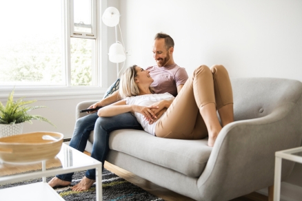 a couple sitting on a couch 