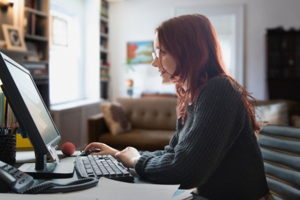 Red headed woman on computer 