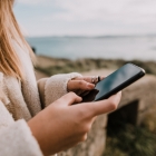 woman outside looking at phone