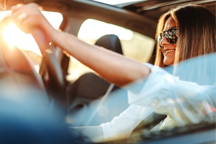 woman in sunglasses driving car