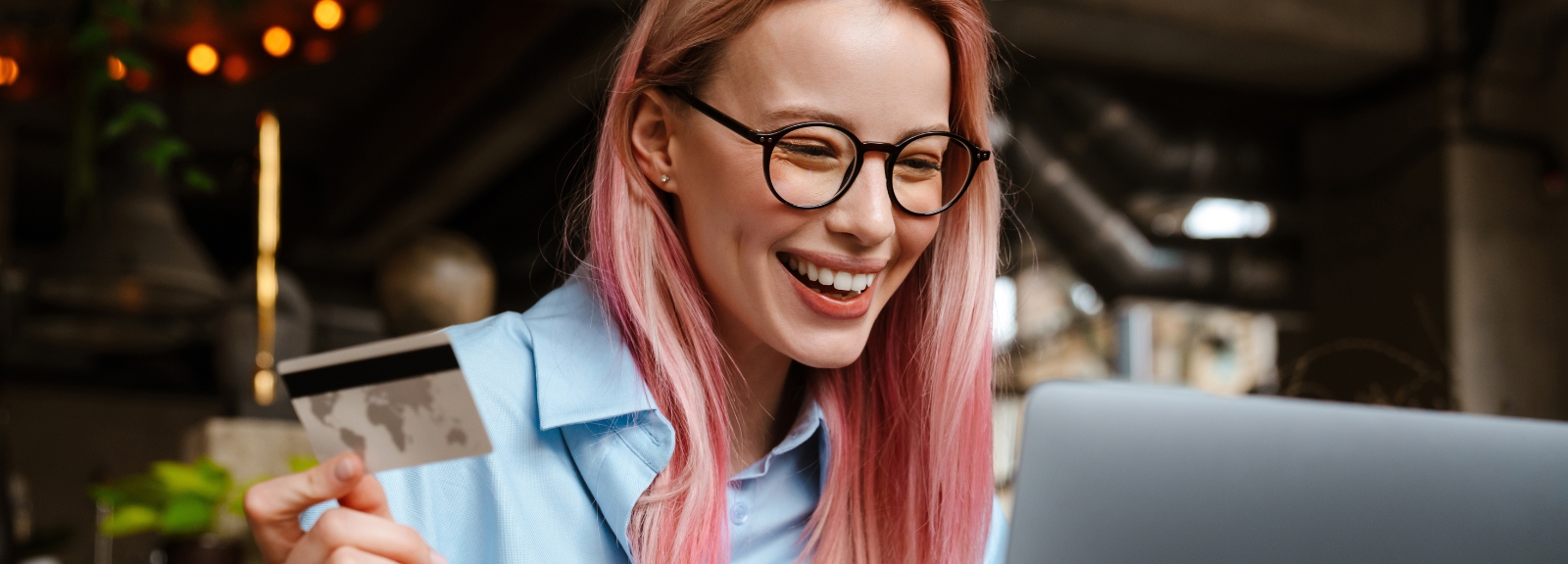 woman with pink hair and glasses