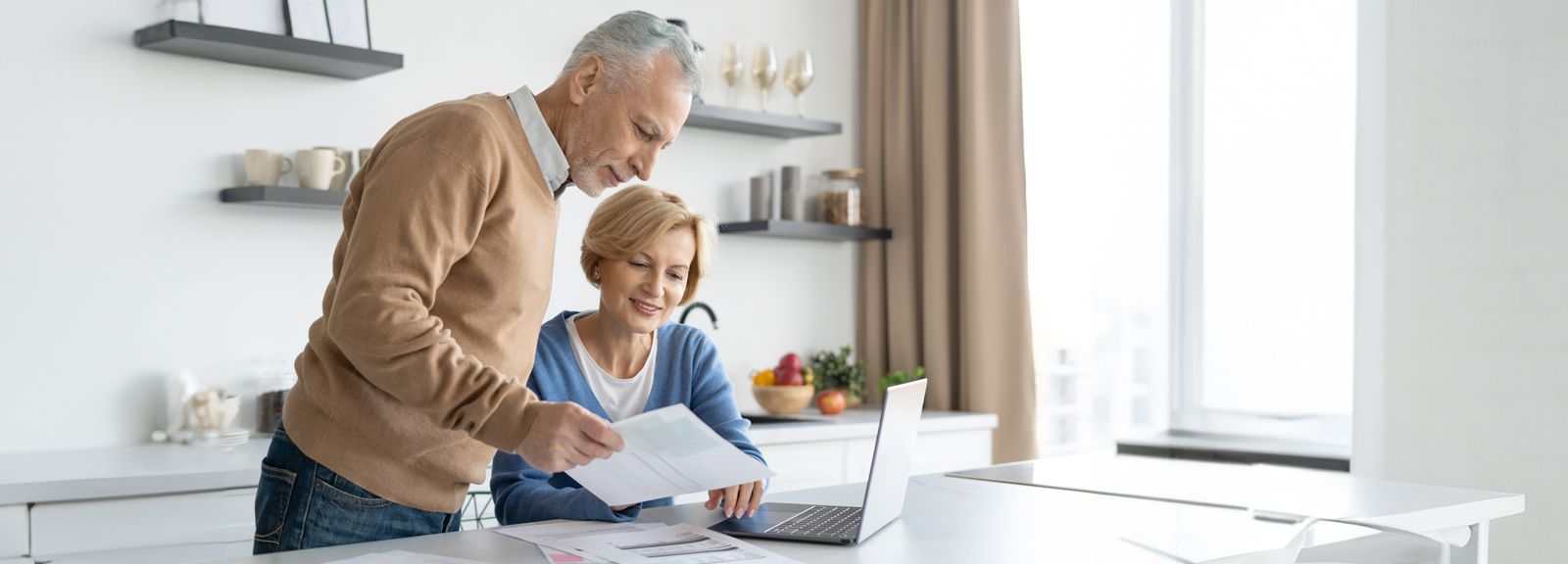 couple doing paperwork in kitchen
