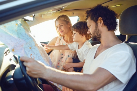 family in cat looking at map