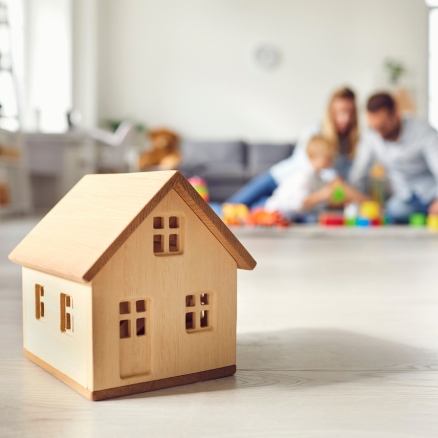 wooden home with family in background 