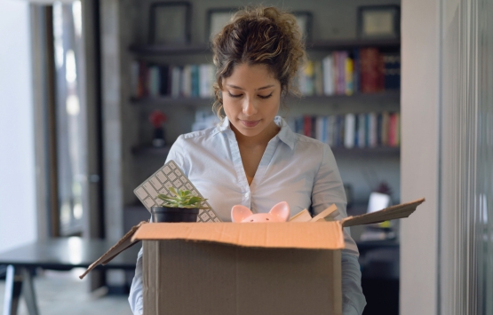 Woman holding box of office stuff