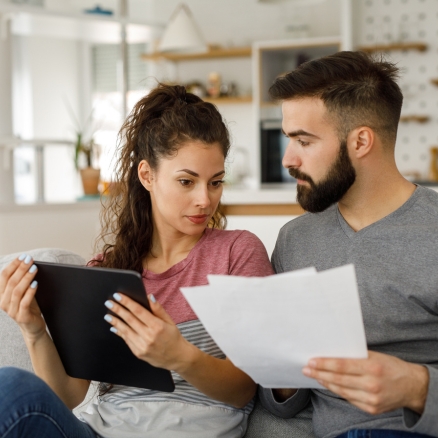 couple looking at bills transfer balance to WyHy 0% Visa