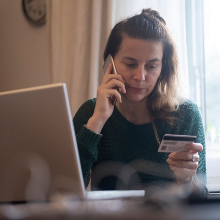 person holding card and phone