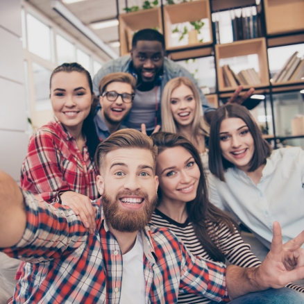 seven people in a group smiling 